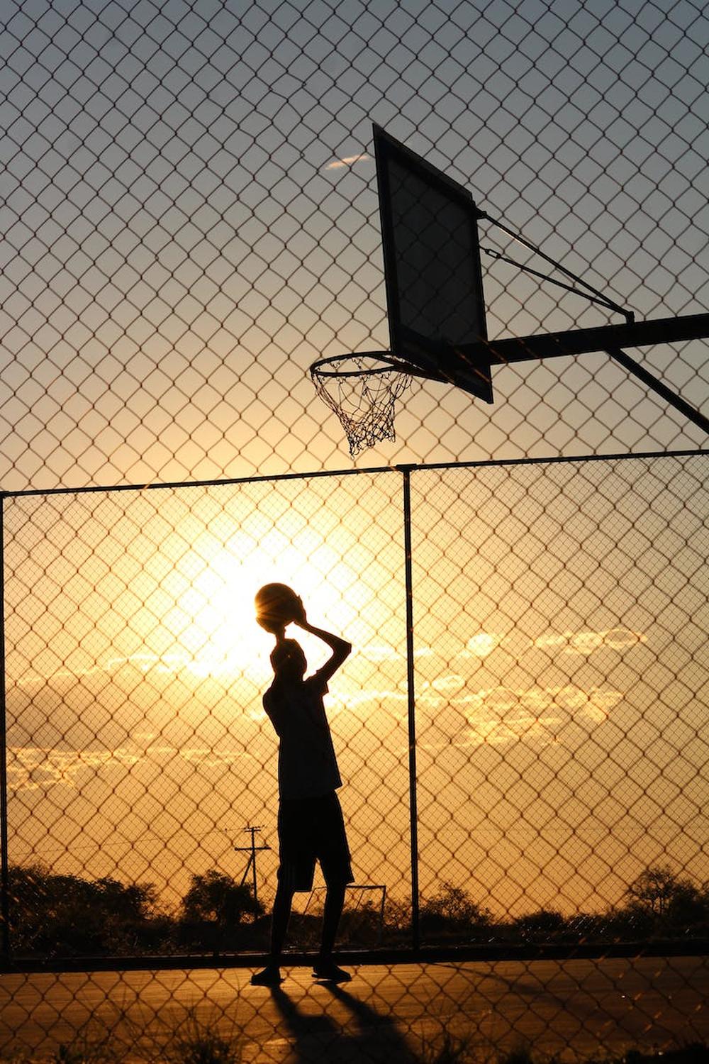 basketball_player_throwing_ball_into_basketball_ho