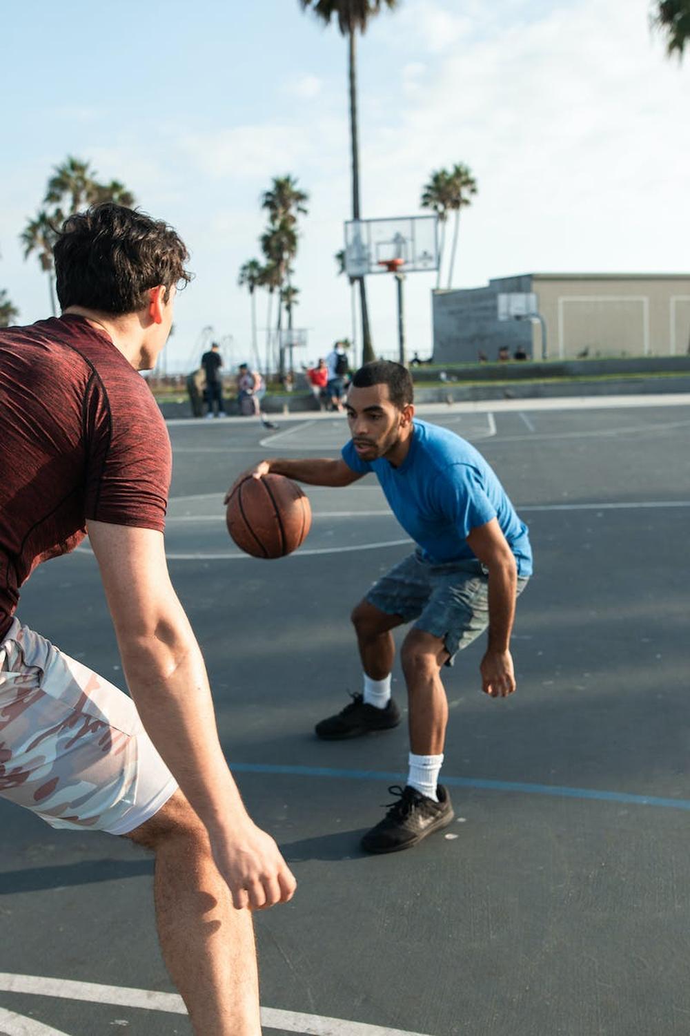 dedicated_diverse_friends_playing_basketball_on_sp