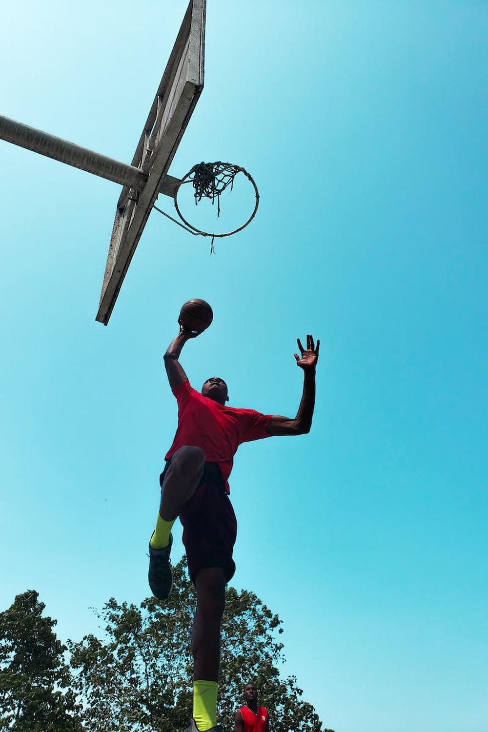 low_angle_photo_of_man_playing_basketball
